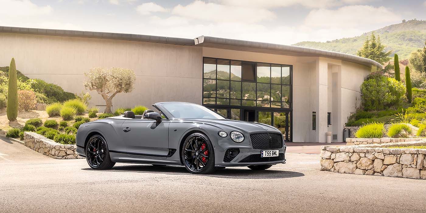 Bentley Monterrey Bentley Continental GTC S convertible in Cambrian Grey paint front 34 static near house