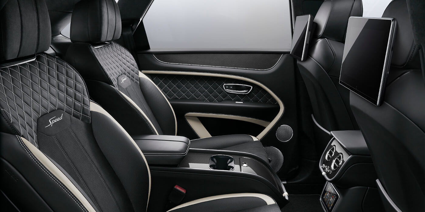 Bentley Monterrey Bentley Bentayga Speed SUV rear interior in Beluga black and Linen hide with carbon fibre veneer