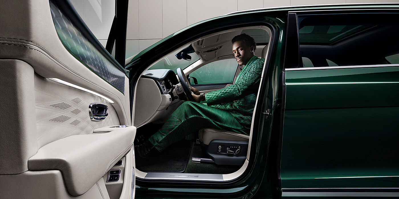 Bentley Monterrey Wisdom K seated in Bentley Bentayga Extended Wheelbase SUV in Light Emerald green paint with door open