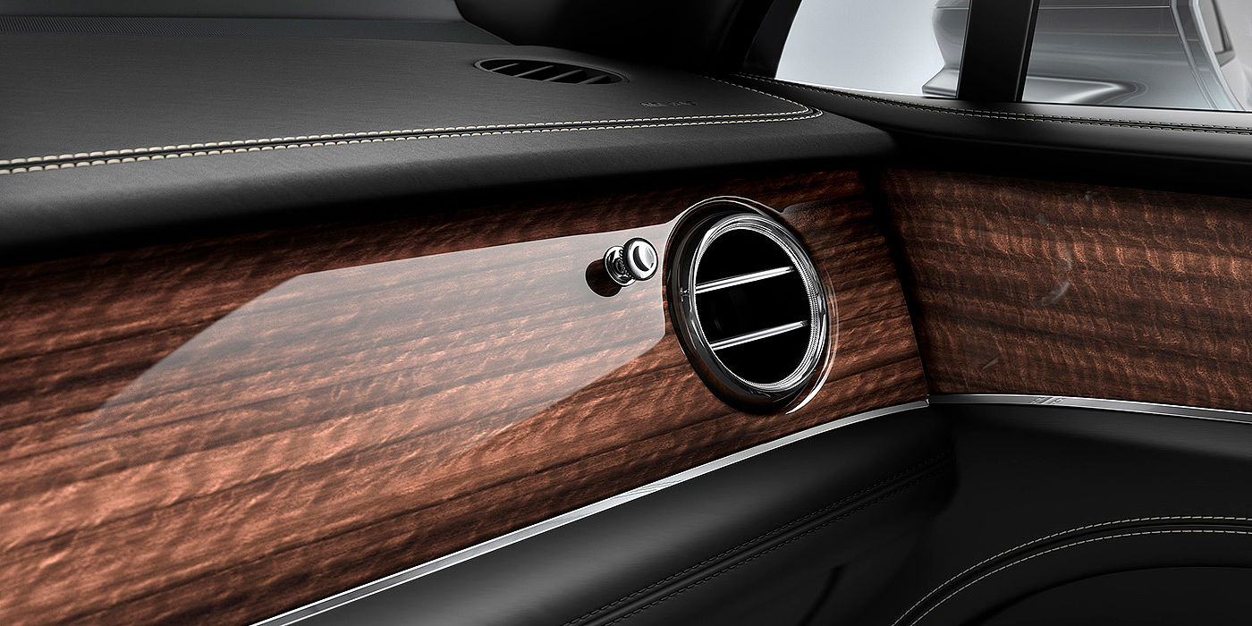 Bentley Monterrey Bentley Bentayga front interior Crown Cut Walnut veneer and chrome air vent.