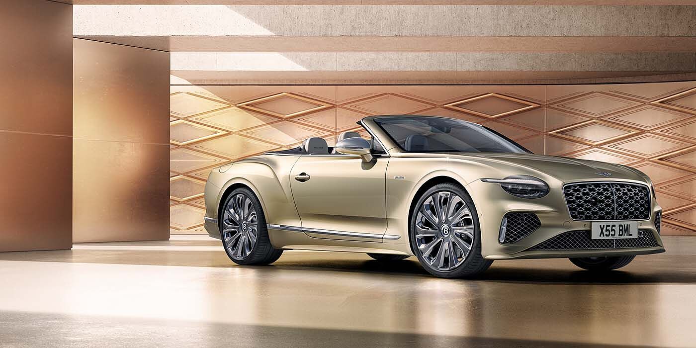 Bentley Monterrey Bentley New Continental GTC Mulliner V8 hybrid front three quarters in Patina paint
