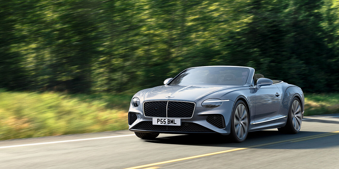 Bentley Monterrey New Bentley Continental GTC convertible front view in Silverlake paint with 22 inch ten spoke wheels, driving dynamically on a country road