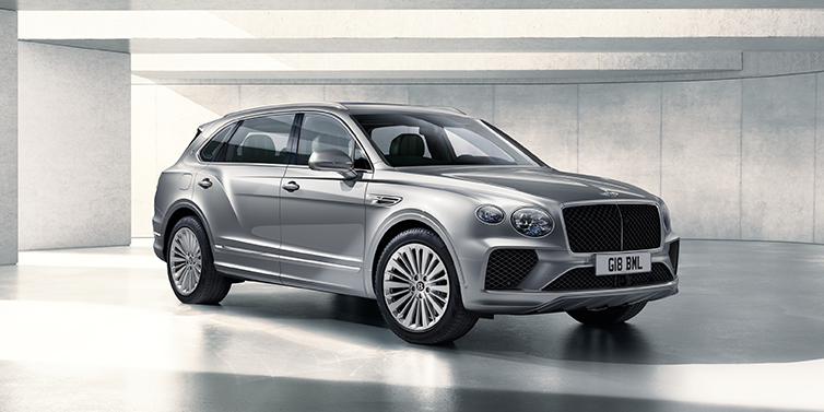 Bentley Monterrey Bentley Bentayga Extended Wheelbase SUV front three quarter in Moonbeam paint with a grey background